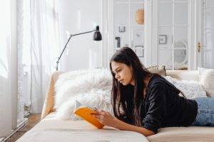  A woman reading a book, signifying the importance of reviewing the syllabus