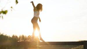 Woman balancing on a beam